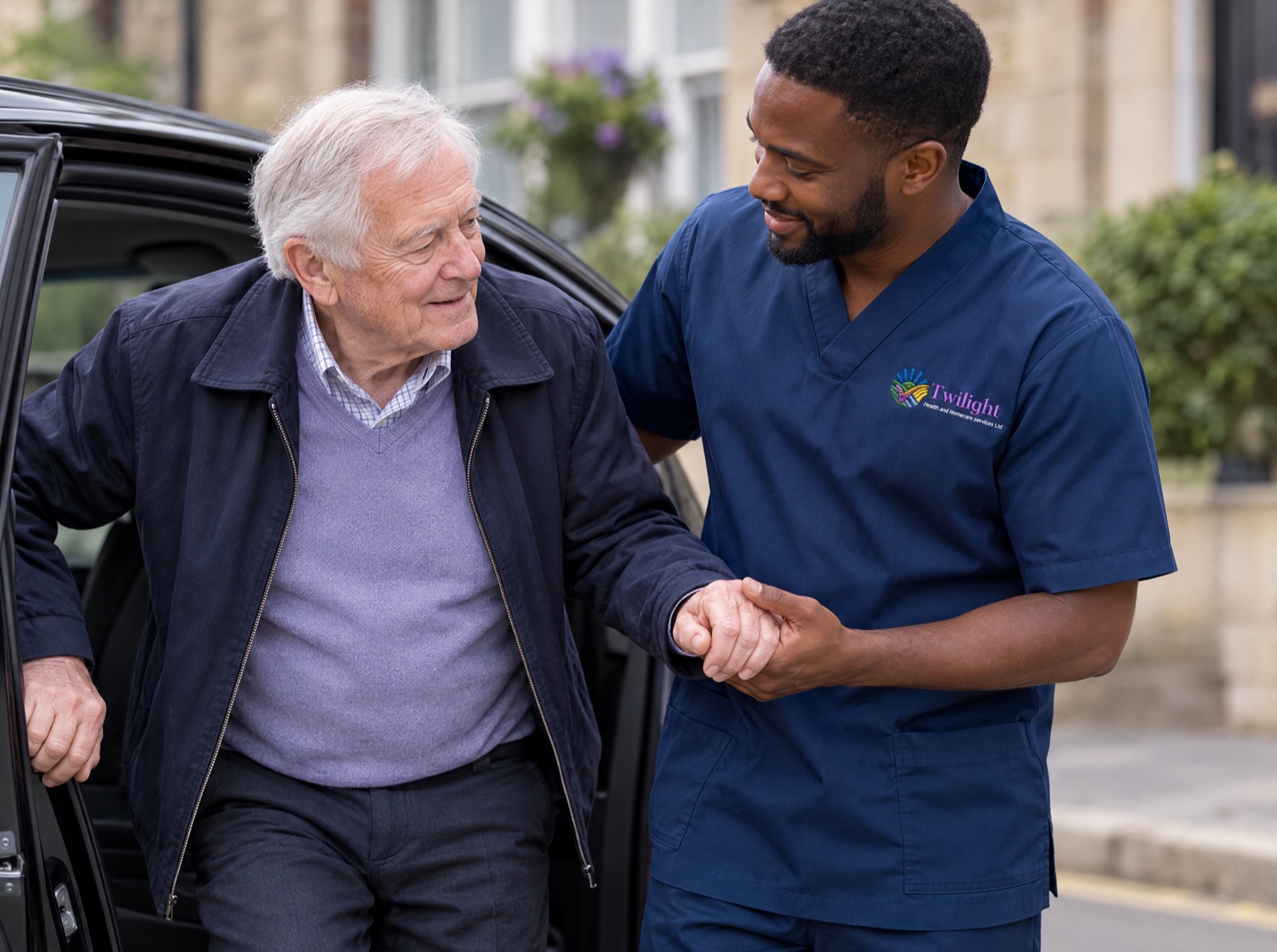 African heritage Twilight carer in a twilight-blue uniform helping an elderly man out of a car at an appointment